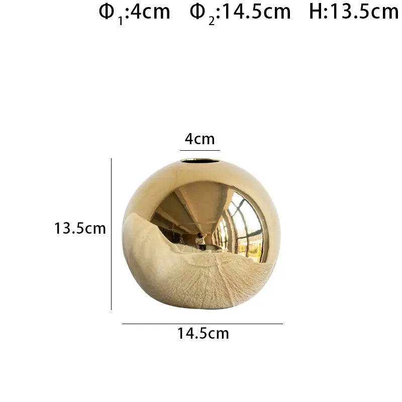 Gold ceramic vase hydroponic display on contemporary shelf