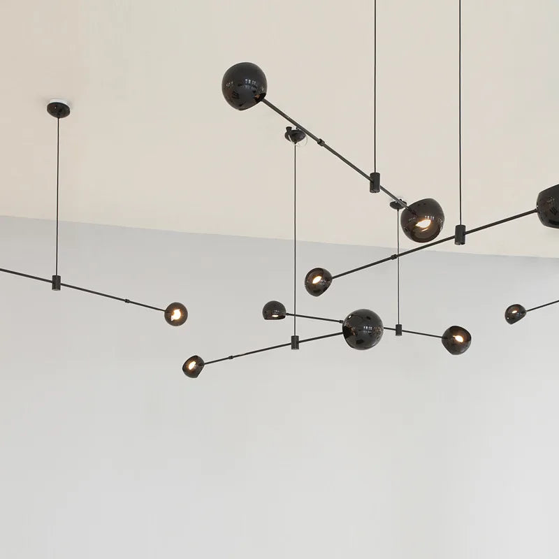 Four globe chandelier on a black wrought iron bar, semi flush mounted