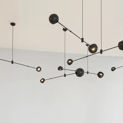 Four globe chandelier on a black wrought iron bar, semi flush mounted