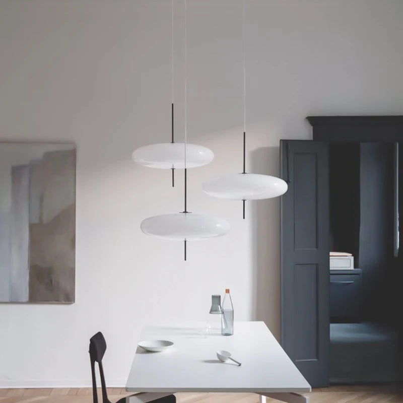 White acrylic chandelier shades at 30 centimetres diameter on iron arms