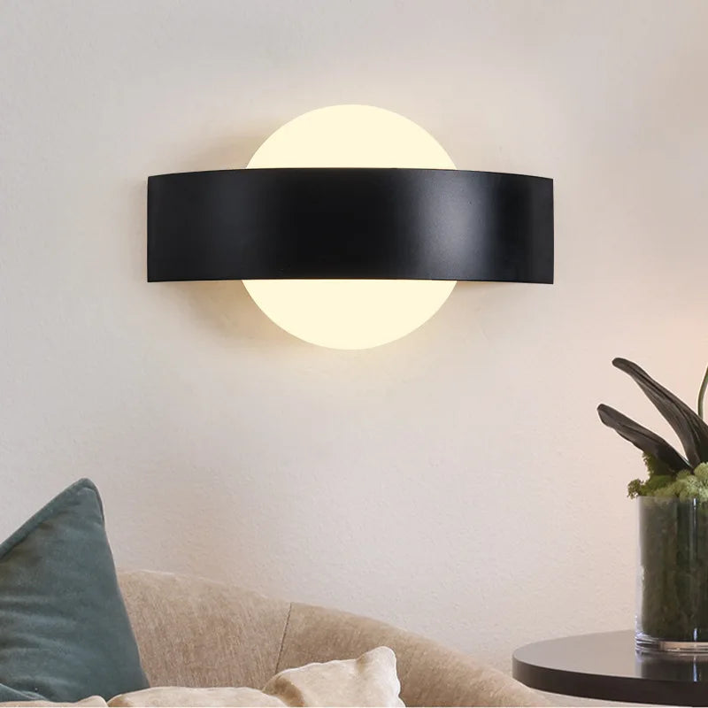 black wall sconce, detail view of fixture base and arm