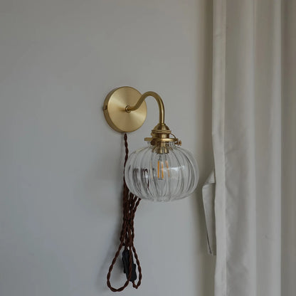 copper plug-in wall sconce, detail view of fixture base and arm