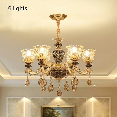French ceramic chandelier shown lit in warm upward E14 light