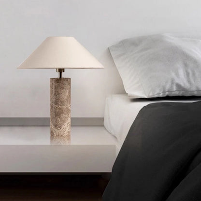 Marble cylinder lamp warm mode casting soft glow on wall