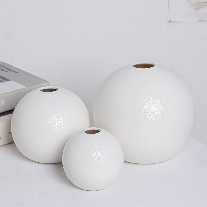 White ceramic ball vase from above showing perfect round opening detail