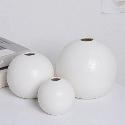White ceramic ball vase from above showing perfect round opening detail