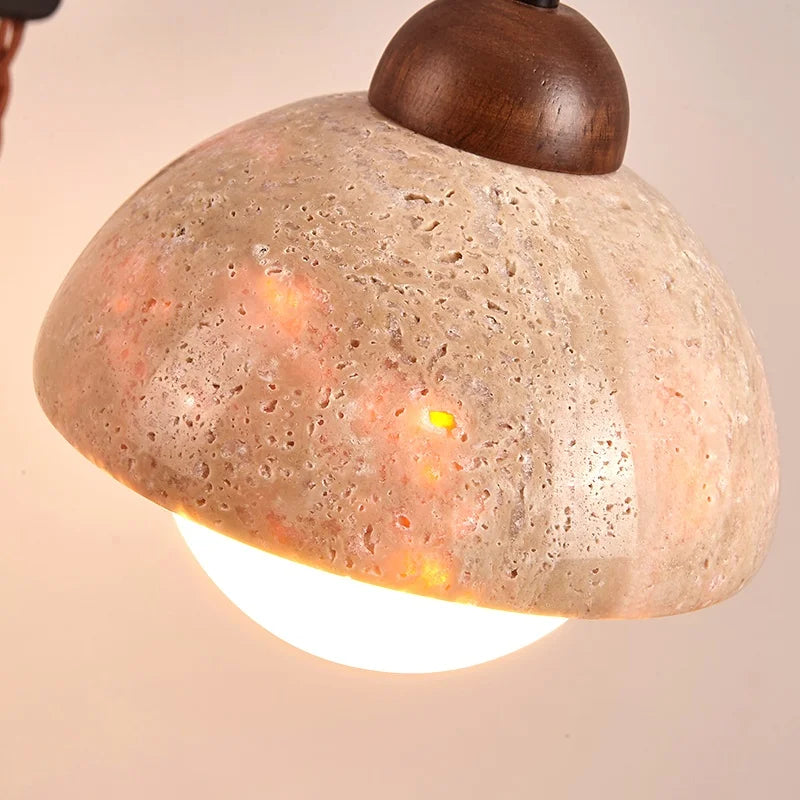 travertine stone wall sconce, detail view of fixture base and arm