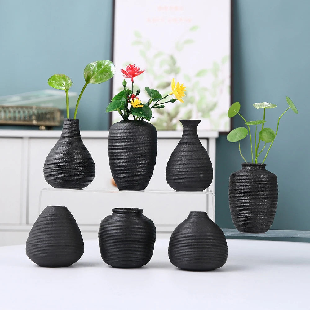 Black ceramic vase style B with curved waisted silhouette holding dried pampas grass