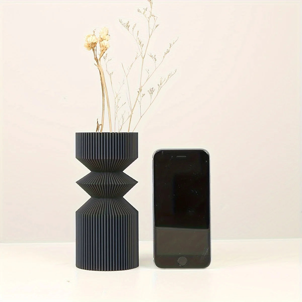 Close-up of smooth matte black plastic surface on Nordic style vase