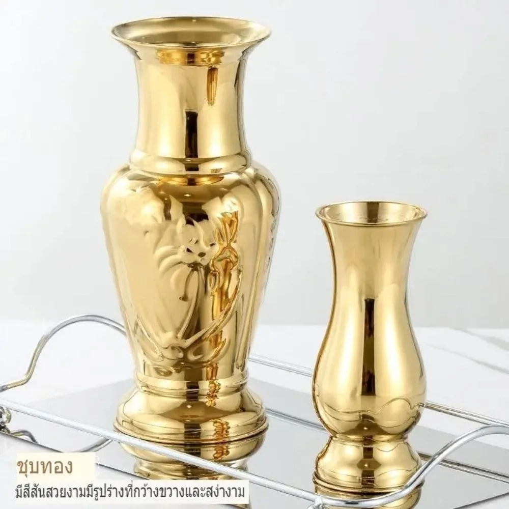 Gold stem vase 7 inch height holding single white lily bloom on console