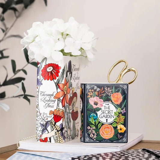 Ceramic stacked book vase in small size on wooden desk with dried flowers