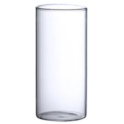 Single clear glass cylinder vase with fresh cut lavender on wooden kitchen counter