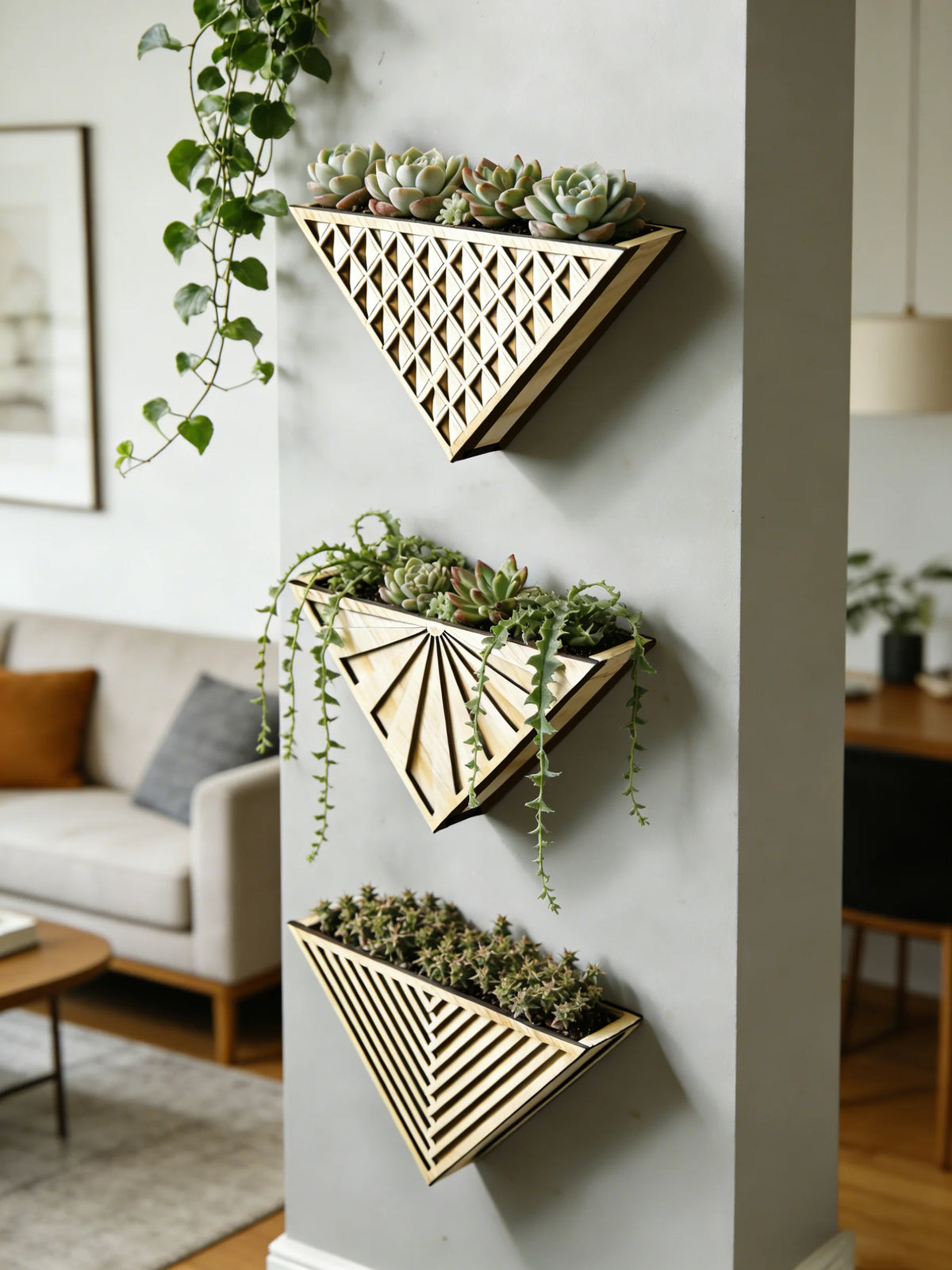 Three sizes of geometric triangle wooden wall planters mounted on wall