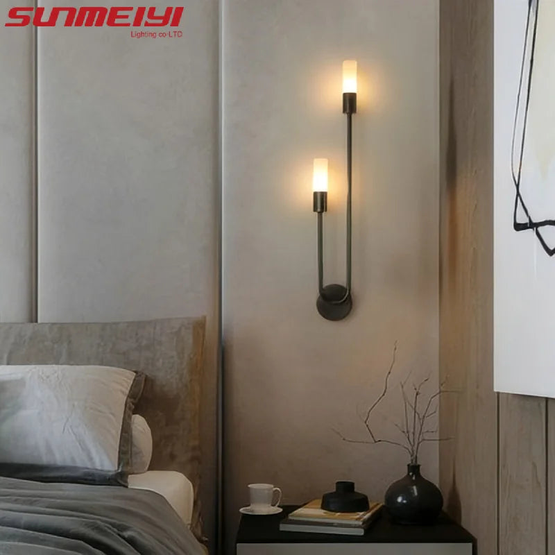 gold wall sconce, detail view of fixture base and arm