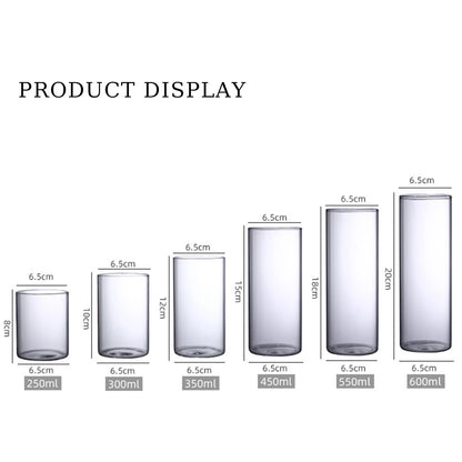Five glass cylinder vases in graduated heights on minimalist shelf display