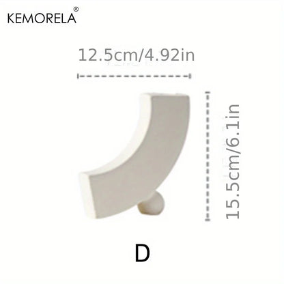 Two Nordic ceramic donut ring vases grouped showing size and style comparison