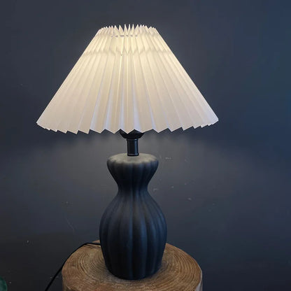 Side profile of black ceramic base with fabric shade detail