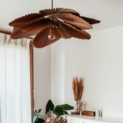 Paper fan chandelier lit from within, casting a soft downward glow