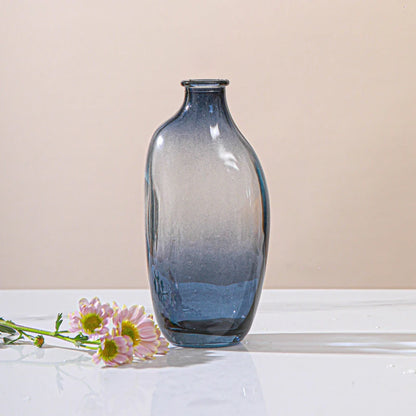 Vintage glass bottle vase styled in eclectic home interior