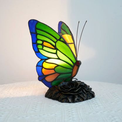 Green butterfly glass lamp close-up showing leaded stained glass detail