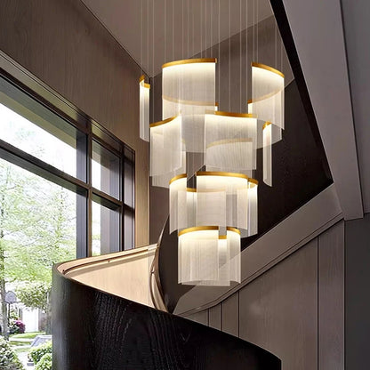 Black framed acrylic chandelier lit in warm white down a void