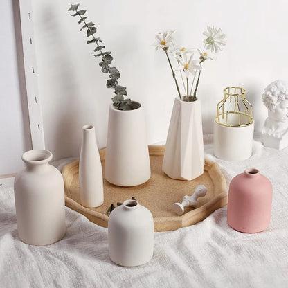 White ceramic Nordic vase style D6 with tall cylindrical form holding dried stems