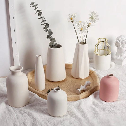 White ceramic Nordic vase style D6 with tall cylindrical form holding dried stems