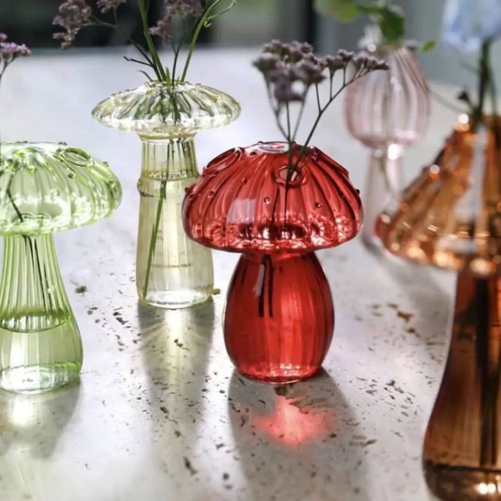 Gold jelly-toned mushroom glass vase with small floral arrangement inside