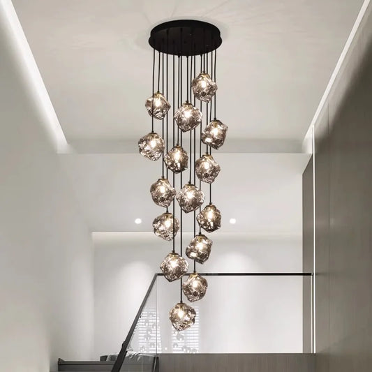 Glass globe staircase chandelier with heads dropping at staggered lengths