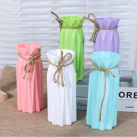 White hemp rope tied ceramic-style plastic vase with dried cotton stems on desk