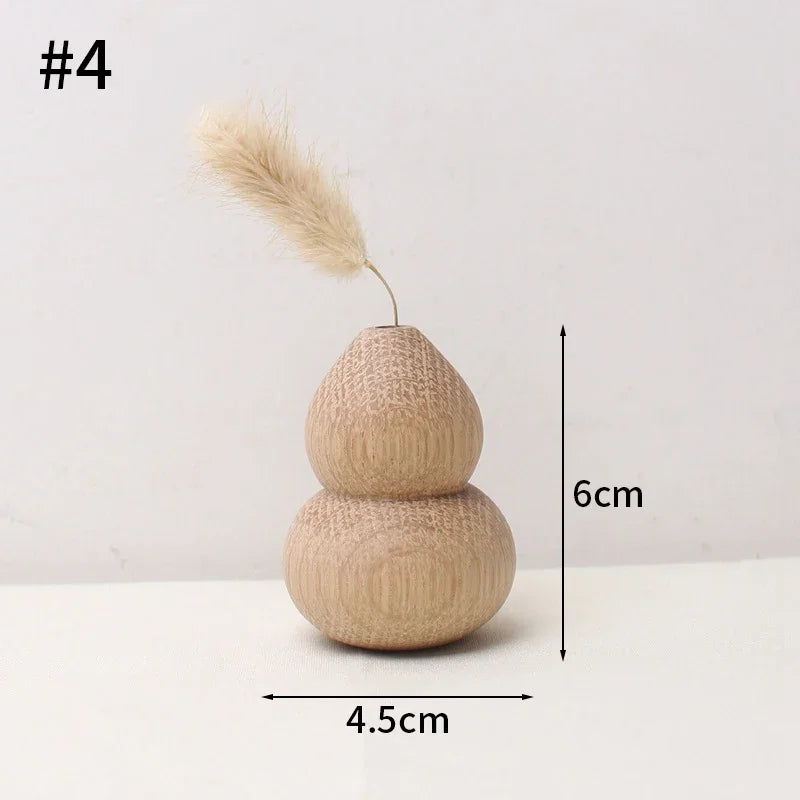 Japanese wooden desk vase with a single dried pampas stem on a light linen surface