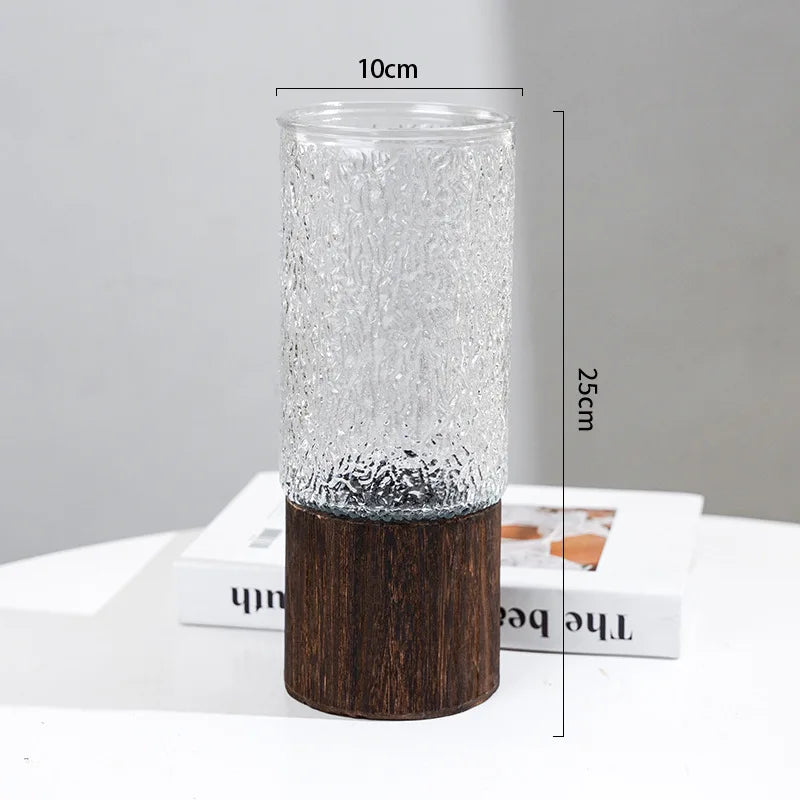Style A glass bud vase with wooden base holding single tulip stem close-up