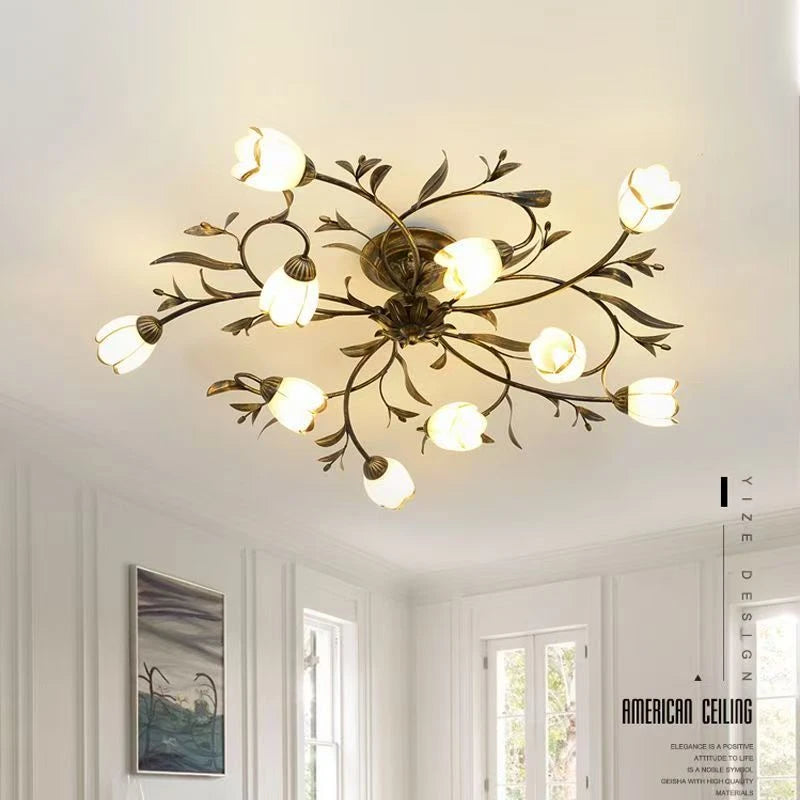Glass blossom shade detail on a dark grey painted iron chandelier branch arm