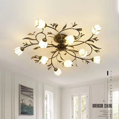 Glass blossom shade detail on a dark grey painted iron chandelier branch arm