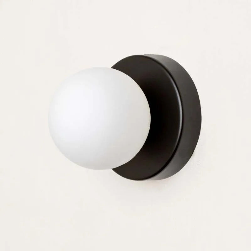 glass outdoor wall sconce, installed in a room interior setting