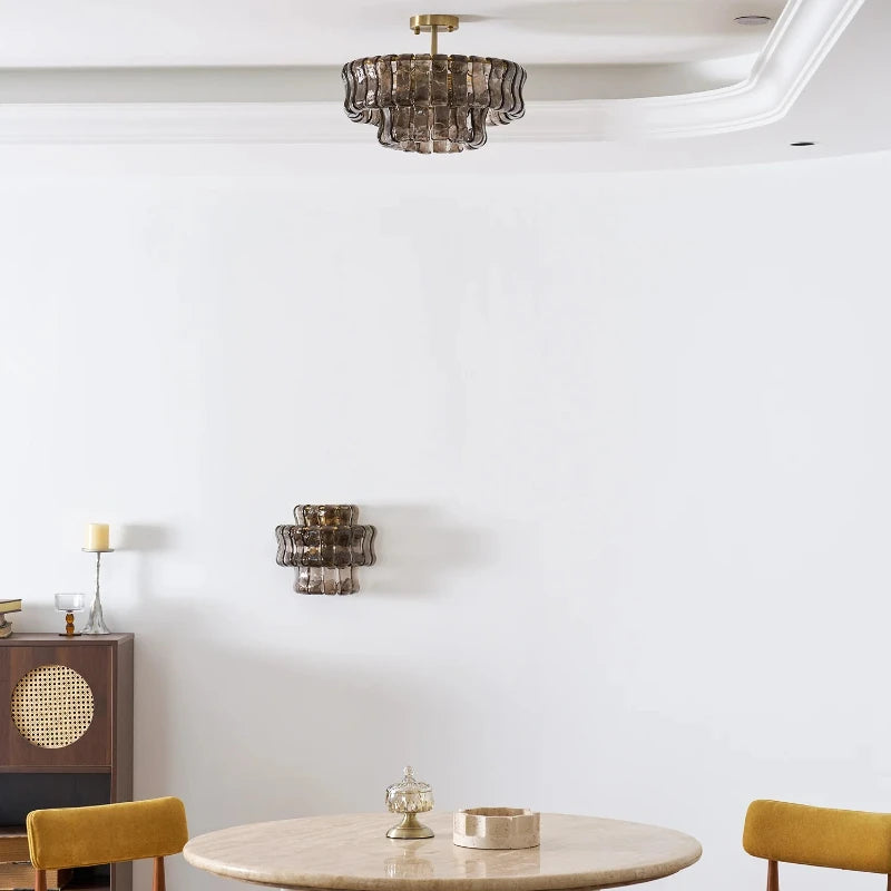 Handcrafted glass element detail on a gold iron chandelier frame