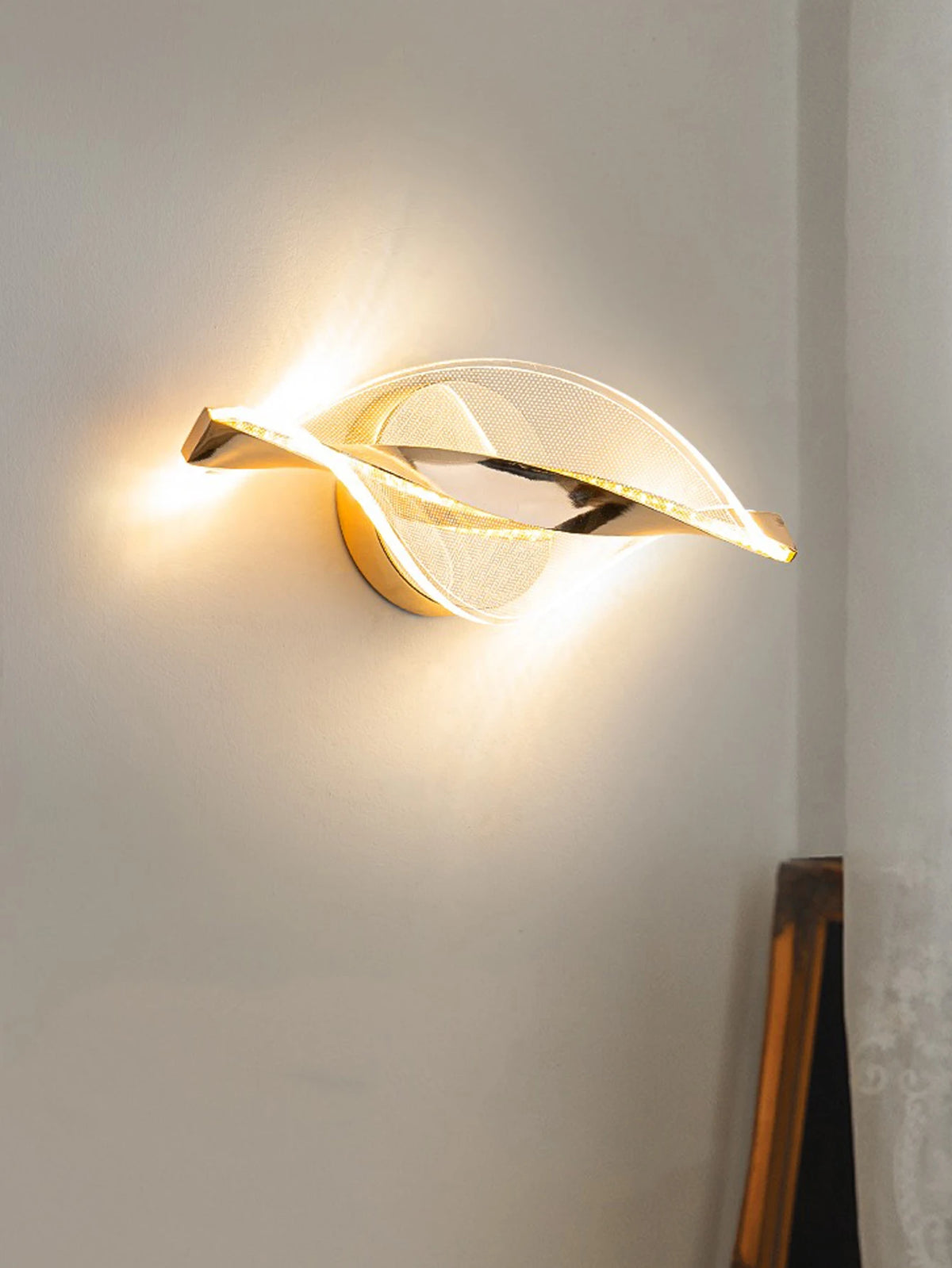 gold and black acrylic outdoor wall sconce, installed in a room interior setting