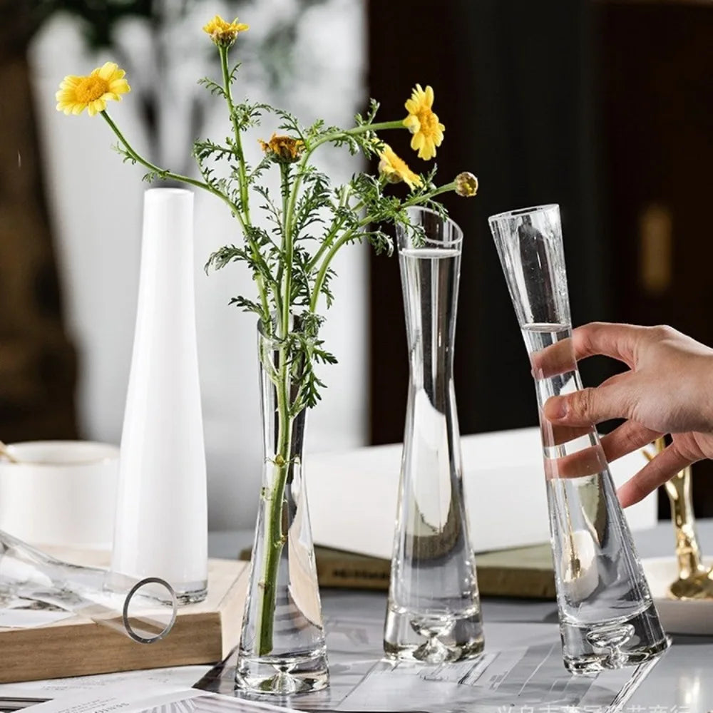 Transparent glass flower vase with tilted rim holding fresh cut flowers