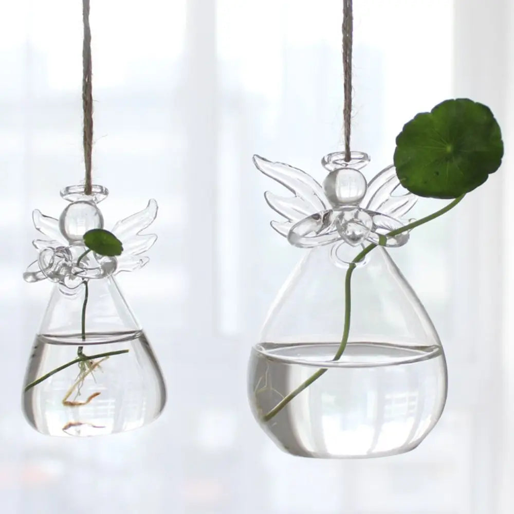 Large glass angel-shaped flower vase on a boho wooden shelf display