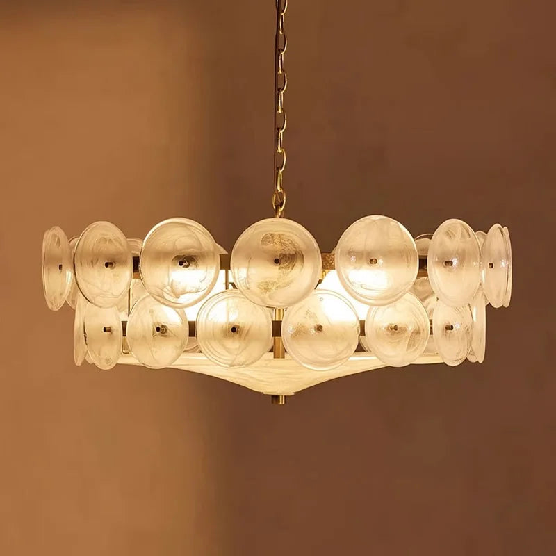 Modern chandelier with rounded clear glass shades on a low iron frame in green