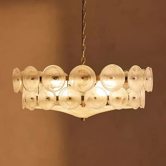 Modern chandelier with rounded clear glass shades on a low iron frame in green