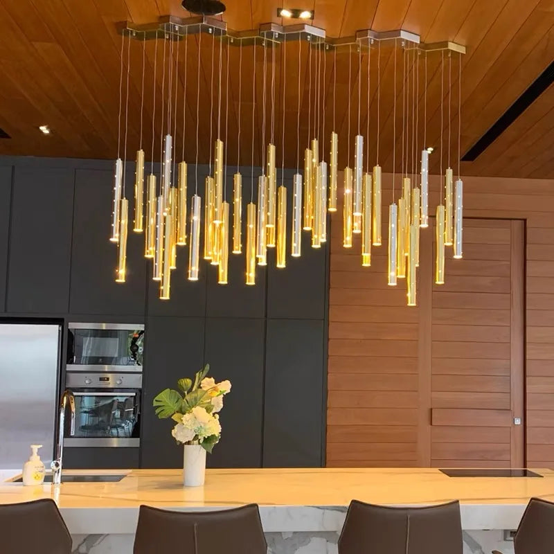 Gold body tube chandelier with acrylic diffusers and cord pendant suspension