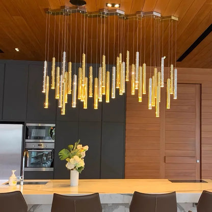 Gold body tube chandelier with acrylic diffusers and cord pendant suspension