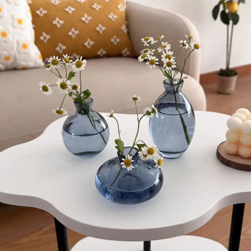 Simple transparent mini glass flower vase on minimalist home desk