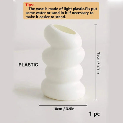 Side view of white spiral plastic vase showing graceful twisted silhouette