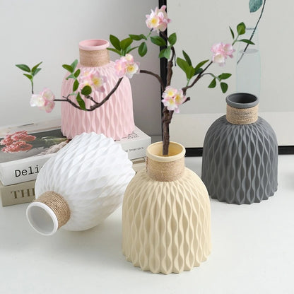Pink plastic flower vase with pineapple texture and natural twine rope accent
