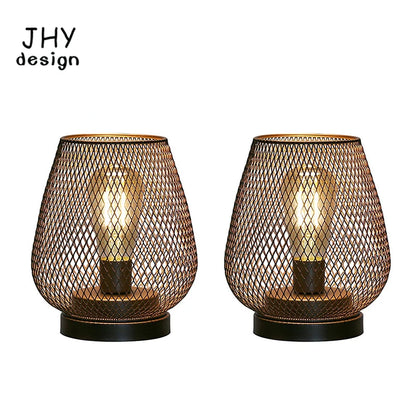 Diamond cage metal table lamp pair LED lit on outdoor dining table