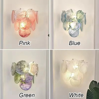 Green stained glass shades ringing a heavy iron chandelier frame