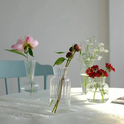 Large Nordic glass bottle vase with dried botanical stems in minimalist interior