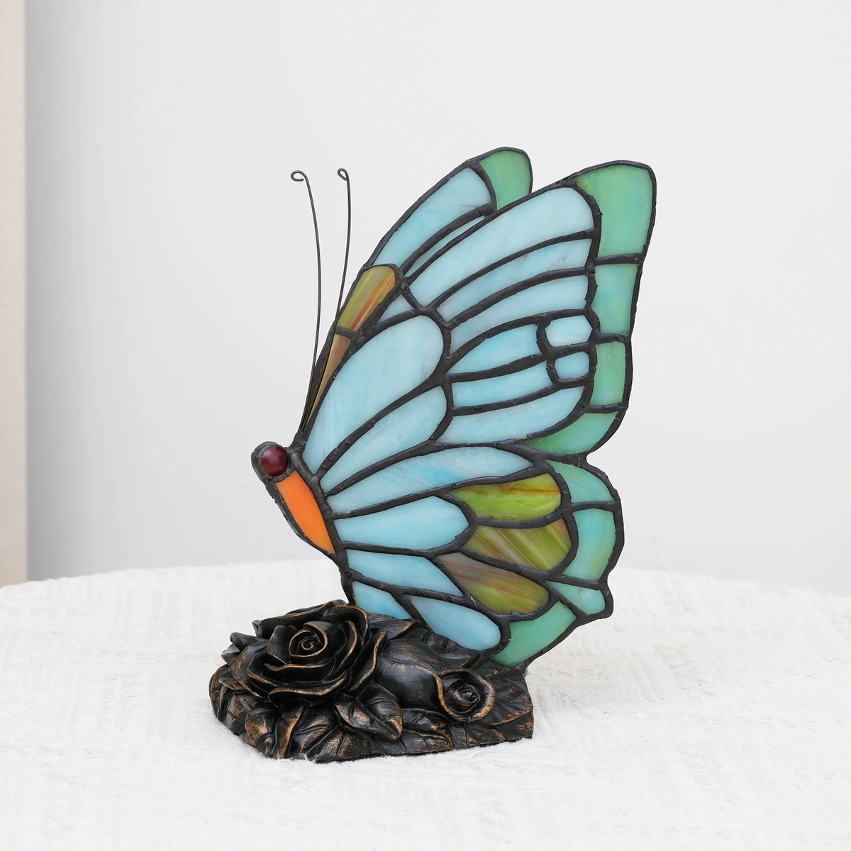 Sky blue butterfly stained glass lamp switched off unlit shade